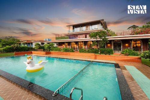 StayVista at Greenwich Meridian with Pool, River & Mountain View
